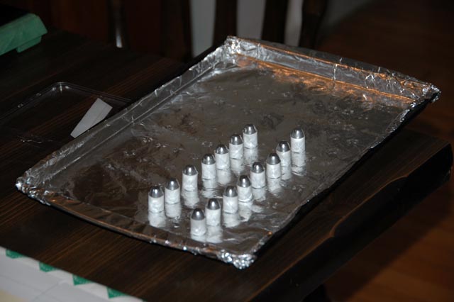 Wrapped bullets in their wet patches are placed on a cookie sheet.